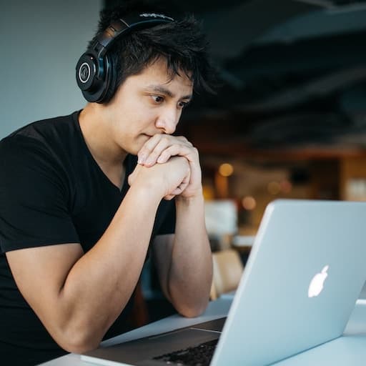 A man watching a course on a laptop